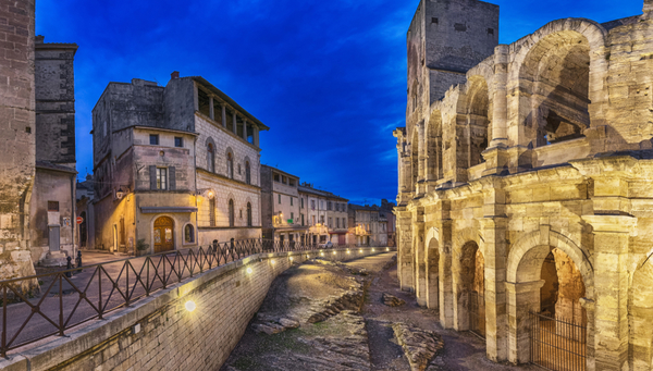 The remarkable Roman amphitheatre at sunset in Arles.