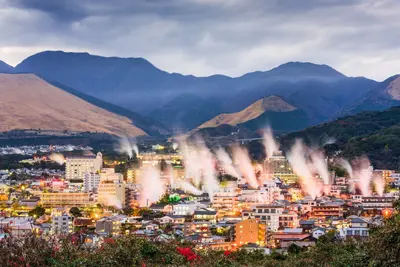 Landscape of a Japanese town with hot spring bathhouses and rising steam
